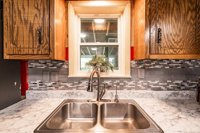 311 Birchwood St, Pikeville, TN 37367 - kitchen featuring light countertops, tasteful backsplash, and brown cabinets