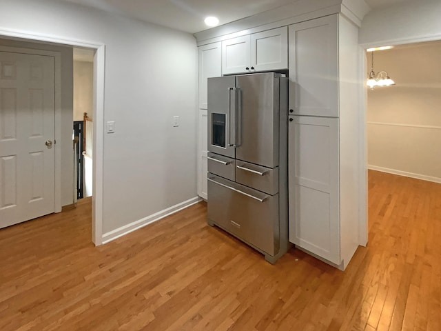 8127 Blue Spruce Dr, Hixson, TN 37343 - kitchen featuring high quality fridge, light wood-style floors, white cabinets, a chandelier, and recessed lighting