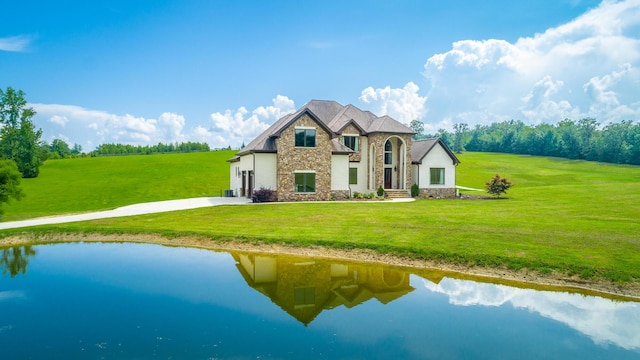 1524 Green Pond Rd, Soddy Daisy, TN 37379 - rear view of property featuring stone siding, concrete driveway, a yard, and a water view