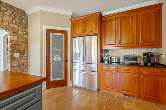 1524 Green Pond Rd, Soddy Daisy, TN 37379 - kitchen with stainless steel fridge with ice dispenser, crown molding, arched walkways, stone tile floors, and backsplash