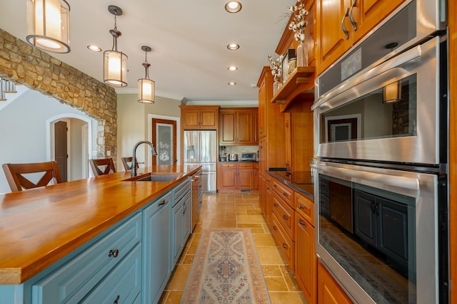 1524 Green Pond Rd, Soddy Daisy, TN 37379 - kitchen with appliances with stainless steel finishes, ornamental molding, wooden counters, recessed lighting, and brown cabinets