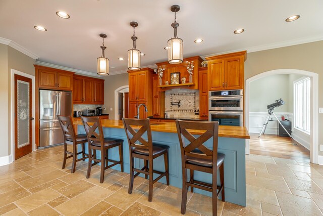 1524 Green Pond Rd, Soddy Daisy, TN 37379 - kitchen featuring appliances with stainless steel finishes, arched walkways, butcher block counters, ornamental molding, and recessed lighting