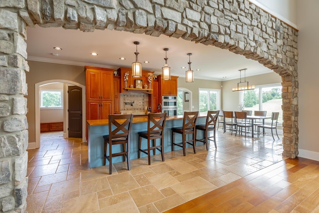 1524 Green Pond Rd, Soddy Daisy, TN 37379 - kitchen with ornamental molding, arched walkways, double oven, recessed lighting, and brown cabinetry