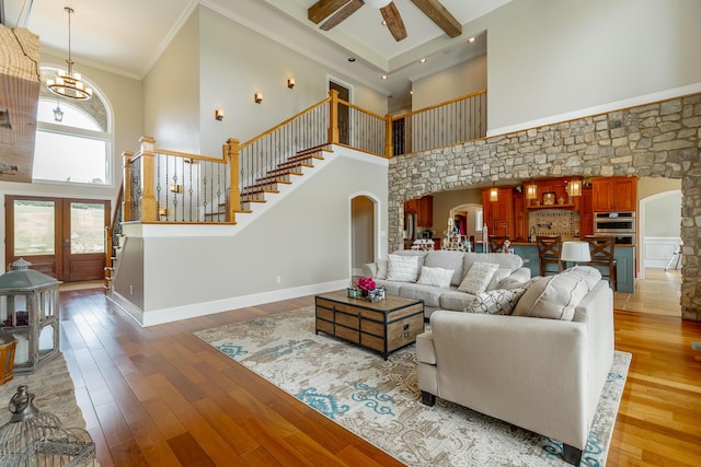 1524 Green Pond Rd, Soddy Daisy, TN 37379 - living area featuring arched walkways, a high ceiling, stairway, hardwood / wood-style floors, and crown molding