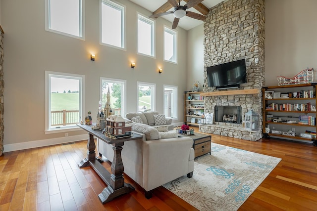 1524 Green Pond Rd, Soddy Daisy, TN 37379 - living area with a ceiling fan, a fireplace, wood finished floors, a towering ceiling, and beamed ceiling