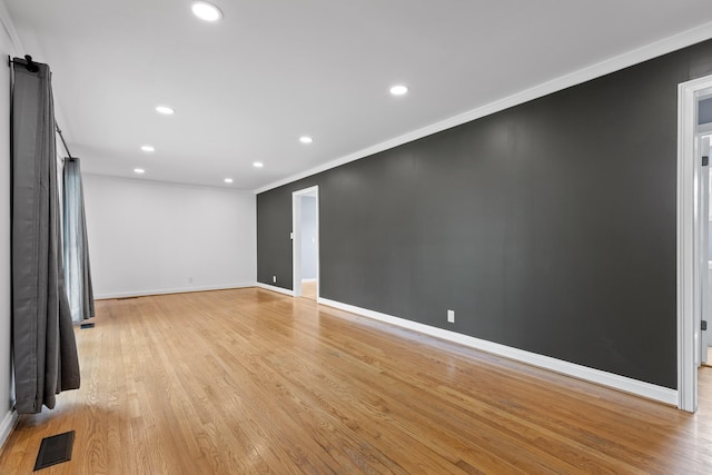 608 Maple Ln, Chattanooga, TN 37412 - empty room with a barn door, ornamental molding, light wood-style flooring, and recessed lighting