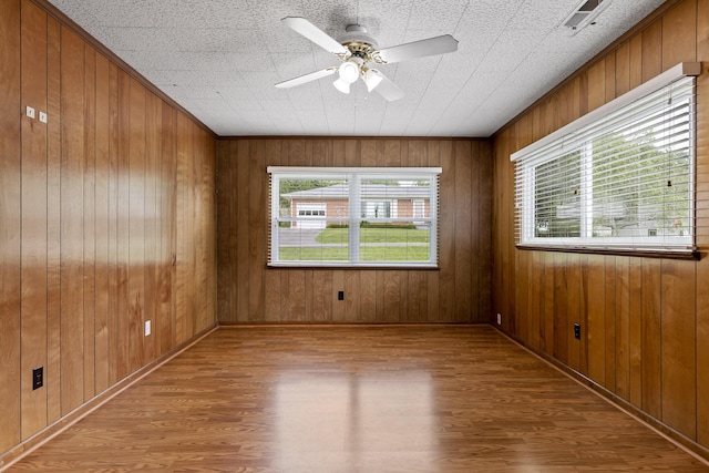 608 Maple Ln, Chattanooga, TN 37412 - empty room with wood finished floors, a ceiling fan, and wooden walls