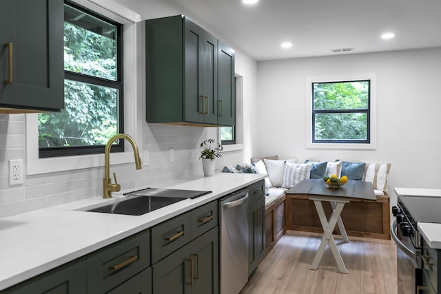 4217 W Rd, Signal Mountain, TN 37377 - kitchen featuring dishwasher, black range with electric stovetop, decorative backsplash, light countertops, and light wood-style floors
