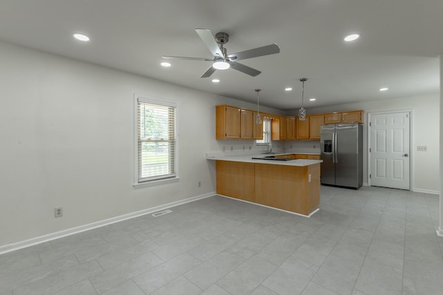 711 2nd St, South Pittsburg, TN 37380 - kitchen with stainless steel fridge with ice dispenser, a peninsula, light countertops, recessed lighting, and a ceiling fan