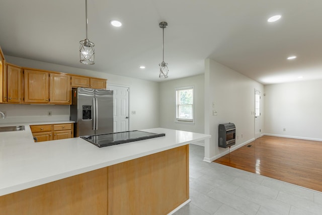 711 2nd St, South Pittsburg, TN 37380 - kitchen featuring stainless steel fridge, black electric cooktop, heating unit, light countertops, and a peninsula