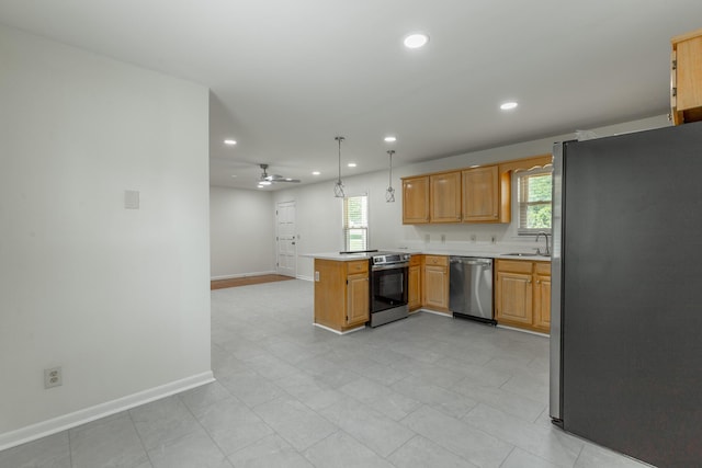 711 2nd St, South Pittsburg, TN 37380 - kitchen with appliances with stainless steel finishes, a peninsula, plenty of natural light, recessed lighting, and light countertops