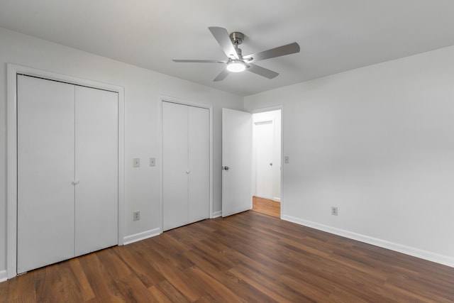 711 2nd St, South Pittsburg, TN 37380 - unfurnished bedroom with two closets, wood finished floors, and ceiling fan