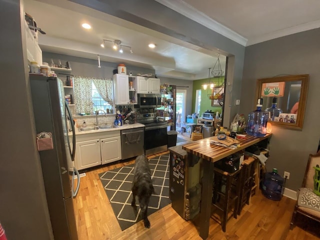 5492 Henson Gap Rd, Dunlap, TN 37327 - kitchen with stainless steel appliances, open shelves, white cabinetry, light wood-style floors, and crown molding