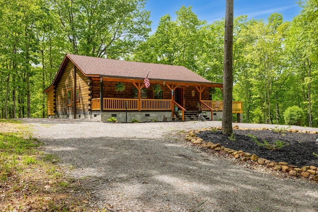 1590 Jackson Point Rd, Sewanee, TN 37375 - log cabin with log exterior, covered porch, gravel driveway, crawl space, and a shingled roof