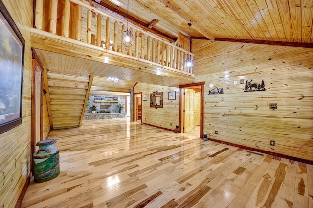 1590 Jackson Point Rd, Sewanee, TN 37375 - unfurnished living room featuring wooden walls, wood-type flooring, a wooden ceiling with exposed beams, and high vaulted ceiling