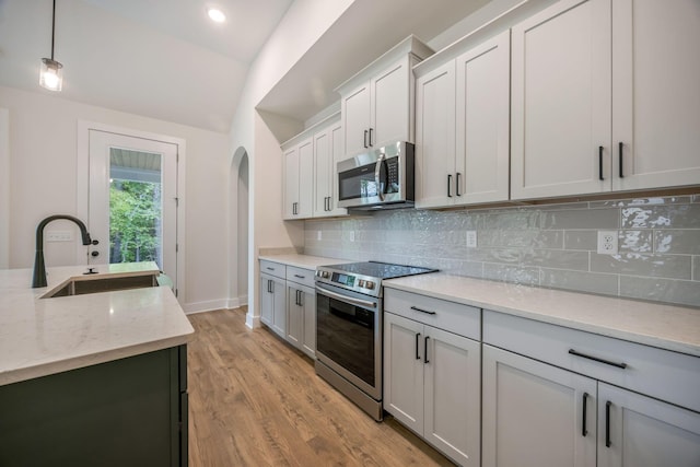 LOT3 Ari Ln, Chattanooga, TN 37421 - kitchen with stainless steel appliances, arched walkways, lofted ceiling, light wood-type flooring, and tasteful backsplash