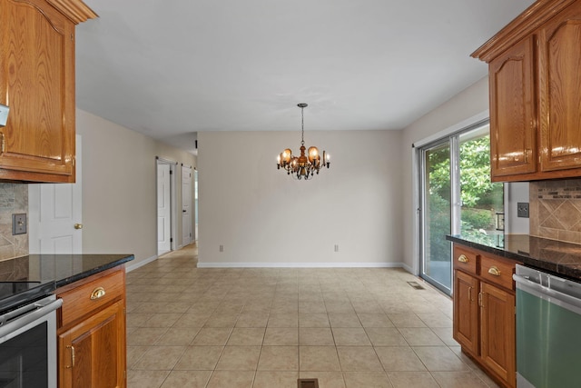 4838 Glenmar Cir, Chattanooga, TN 37416 - kitchen with appliances with stainless steel finishes, decorative backsplash, a chandelier, brown cabinets, and light tile patterned floors