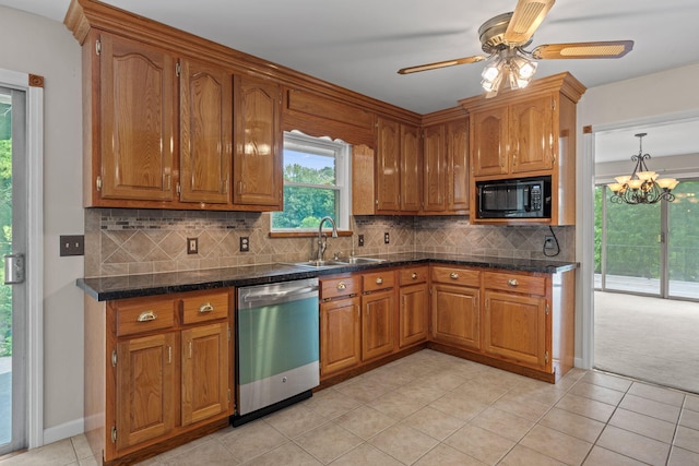 4838 Glenmar Cir, Chattanooga, TN 37416 - kitchen with stainless steel dishwasher, black microwave, brown cabinetry, ceiling fan, and light tile patterned floors