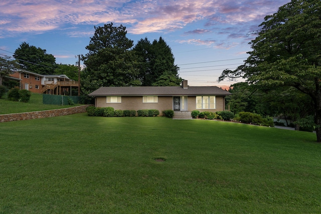 4838 Glenmar Cir, Chattanooga, TN 37416 - view of front facade with a yard, a chimney, and brick siding