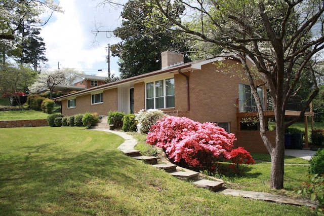 4838 Glenmar Cir, Chattanooga, TN 37416 - view of side of property featuring brick siding, a chimney, and a lawn