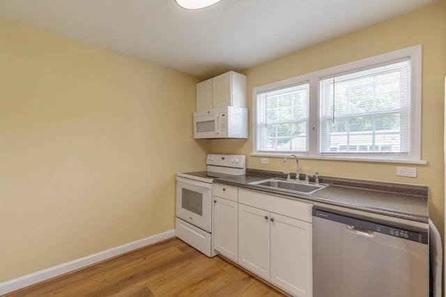 129 N Moore Rd, Chattanooga, TN 37411 - kitchen featuring white appliances, dark countertops, light wood-type flooring, and white cabinetry