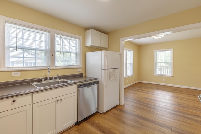 129 N Moore Rd, Chattanooga, TN 37411 - kitchen with dishwasher, dark countertops, freestanding refrigerator, and light wood finished floors