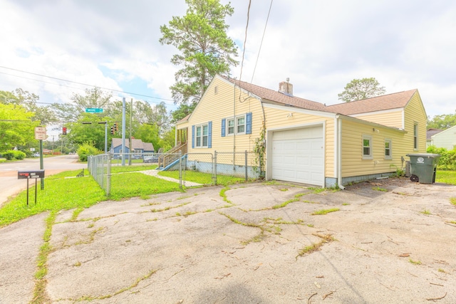 129 N Moore Rd, Chattanooga, TN 37411 - view of property exterior with a garage, driveway, a chimney, a gate, and crawl space