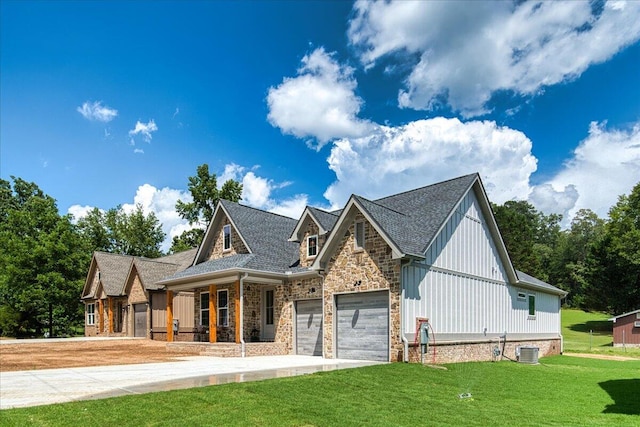 824 Lower Mill Rd, Hixson, TN 37343 - view of front of property with a front lawn, board and batten siding, covered porch, stone siding, and an attached garage