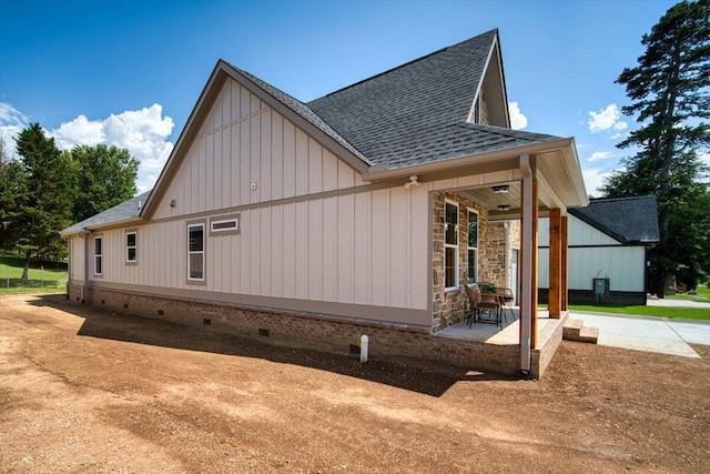 824 Lower Mill Rd, Hixson, TN 37343 - view of side of home featuring roof with shingles, crawl space, board and batten siding, and a patio area