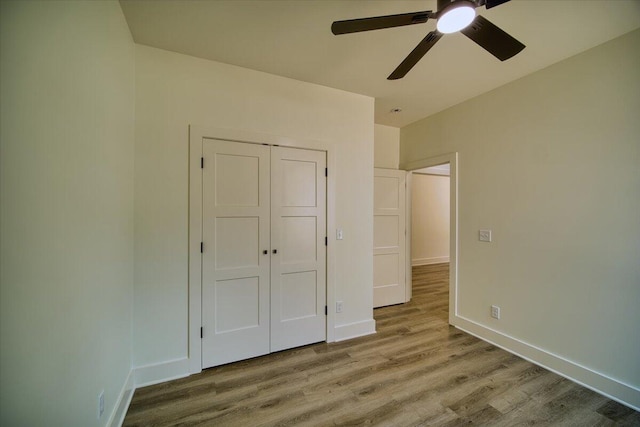 824 Lower Mill Rd, Hixson, TN 37343 - unfurnished bedroom with wood finished floors, a ceiling fan, and a closet