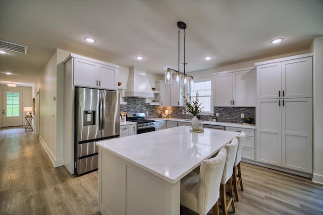 824 Lower Mill Rd, Hixson, TN 37343 - kitchen with appliances with stainless steel finishes, custom exhaust hood, plenty of natural light, backsplash, and recessed lighting