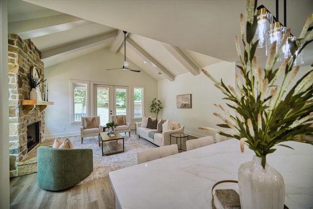 824 Lower Mill Rd, Hixson, TN 37343 - living area with beam ceiling, wood finished floors, ceiling fan, a stone fireplace, and high vaulted ceiling