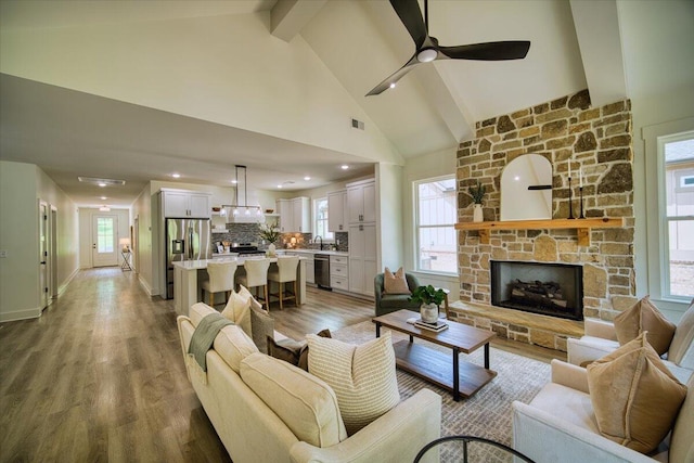 824 Lower Mill Rd, Hixson, TN 37343 - living area featuring light wood finished floors, a ceiling fan, a fireplace, beamed ceiling, and high vaulted ceiling