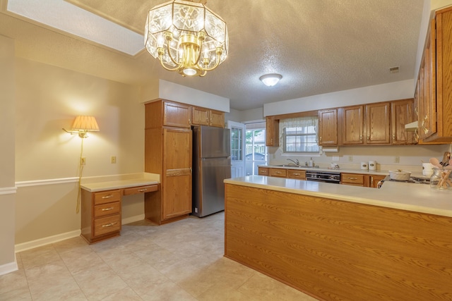 6580 Hickory Meadow Dr, Chattanooga, TN 37421 - kitchen featuring freestanding refrigerator, black dishwasher, brown cabinets, a textured ceiling, and light countertops