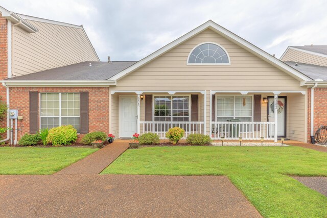 6580 Hickory Meadow Dr, Chattanooga, TN 37421 - view of front of house with brick siding, covered porch, and a front yard