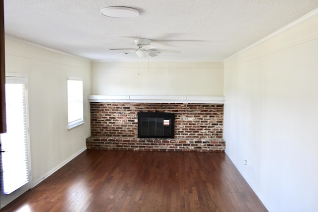 8257 Tiber Rd, Chattanooga, TN 37421 - unfurnished living room with dark wood finished floors, a ceiling fan, a textured ceiling, crown molding, and a brick fireplace