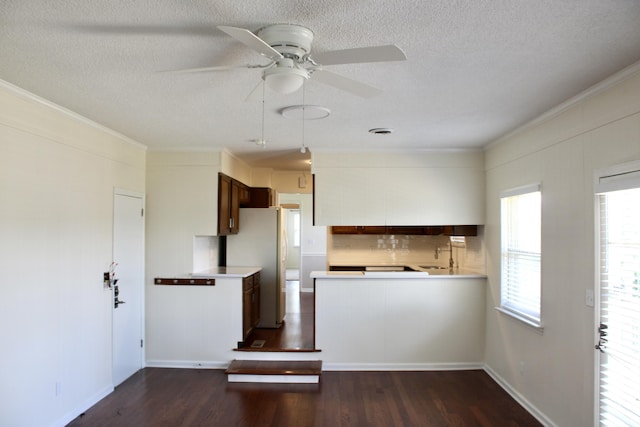 8257 Tiber Rd, Chattanooga, TN 37421 - kitchen featuring freestanding refrigerator, ceiling fan, a textured ceiling, ornamental molding, and light countertops