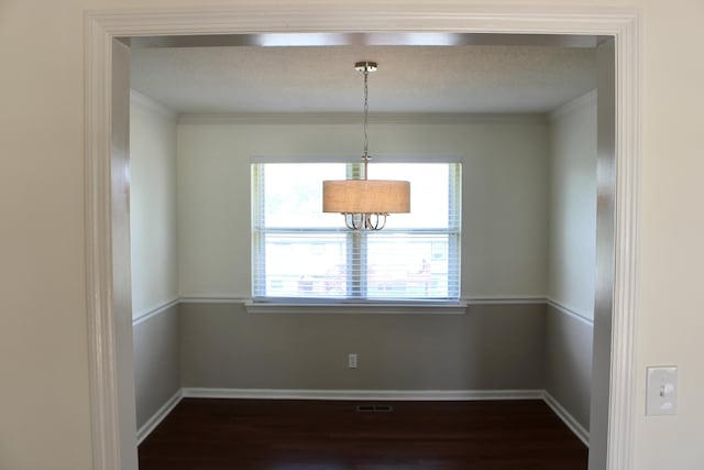8257 Tiber Rd, Chattanooga, TN 37421 - unfurnished dining area with dark wood finished floors and crown molding