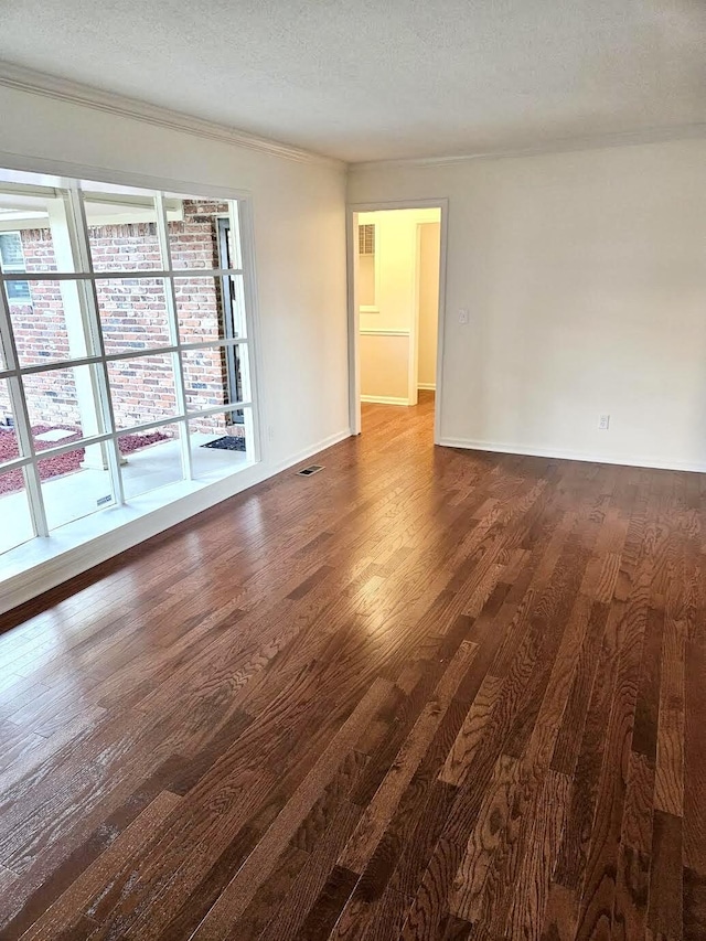 8257 Tiber Rd, Chattanooga, TN 37421 - spare room featuring dark wood finished floors, ornamental molding, and a textured ceiling