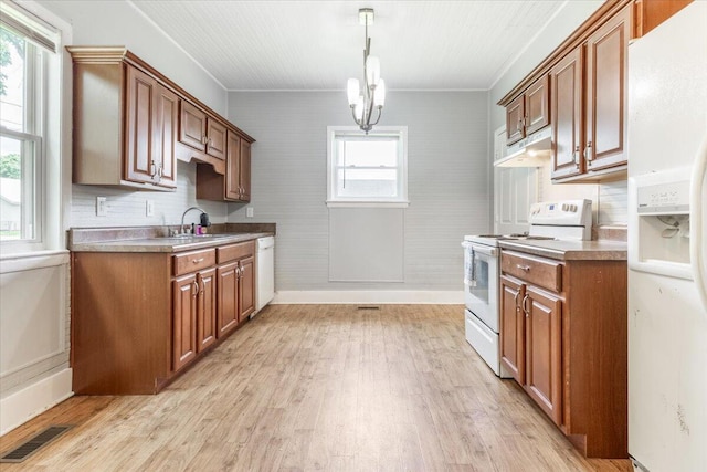 1 W 10th St, Chickamauga, GA 30707 - kitchen featuring white appliances, brown cabinetry, light wood-style floors, a chandelier, and ornamental molding