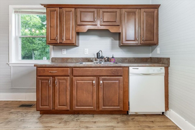 1 W 10th St, Chickamauga, GA 30707 - kitchen with dishwasher, light wood-style floors, brown cabinetry, and dark countertops