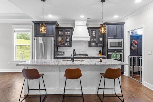 853 Dedmon Rd, Ringgold, GA 30736 - kitchen featuring stainless steel appliances, custom range hood, a breakfast bar area, crown molding, and decorative backsplash