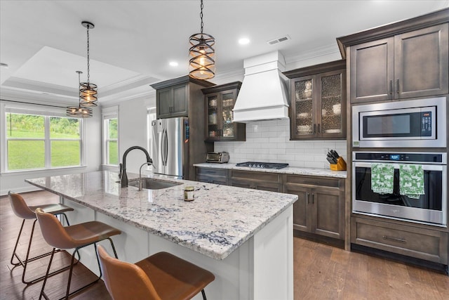 853 Dedmon Rd, Ringgold, GA 30736 - kitchen with stainless steel appliances, custom range hood, dark wood-style flooring, a raised ceiling, and dark brown cabinets