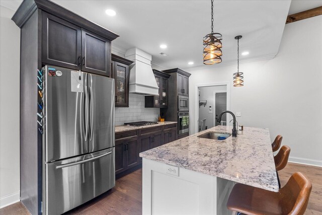 853 Dedmon Rd, Ringgold, GA 30736 - kitchen featuring appliances with stainless steel finishes, custom range hood, decorative backsplash, a kitchen breakfast bar, and dark wood-style flooring