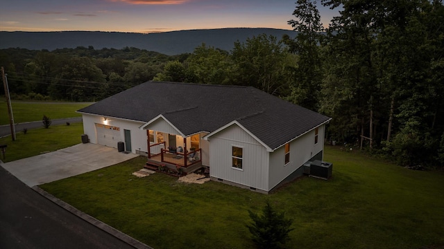 111 Oak Meadow Dr, Dunlap, TN 37327 - view of front of home with driveway, roof with shingles, a lawn, an attached garage, and a forest view
