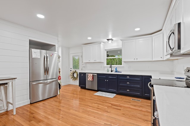 111 Oak Meadow Dr, Dunlap, TN 37327 - kitchen with appliances with stainless steel finishes, white cabinetry, light wood-type flooring, light countertops, and recessed lighting