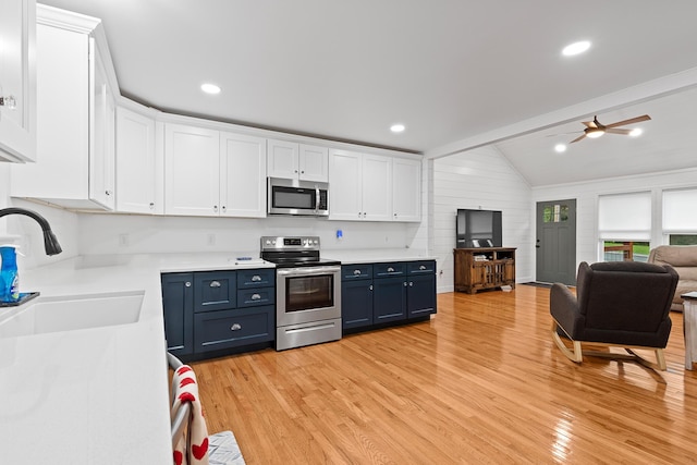 111 Oak Meadow Dr, Dunlap, TN 37327 - kitchen with stainless steel appliances, blue cabinets, white cabinetry, light wood finished floors, and light countertops