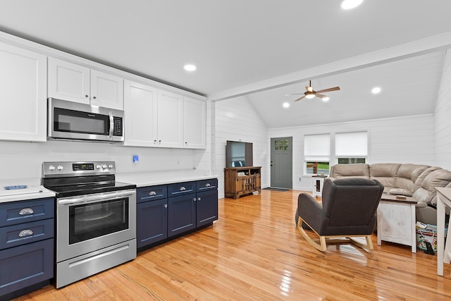111 Oak Meadow Dr, Dunlap, TN 37327 - kitchen with appliances with stainless steel finishes, blue cabinetry, white cabinetry, lofted ceiling, and wooden walls