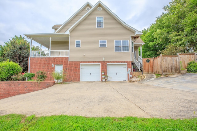 199 Falcons View Dr, Ringgold, GA 30736 - view of side of property with concrete driveway, an attached garage, brick siding, and stairway