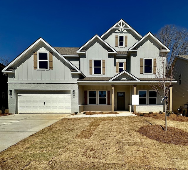 1554 Firelight Way Unit 56, Ooltewah, TN 37363 - view of front of property with board and batten siding, an attached garage, concrete driveway, and brick siding